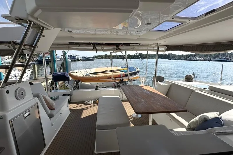 Slide: The Image of Spacious deck of 2014 Fountaine Pajot Helia 44 catamaran with seating and scenic marina view. - 6