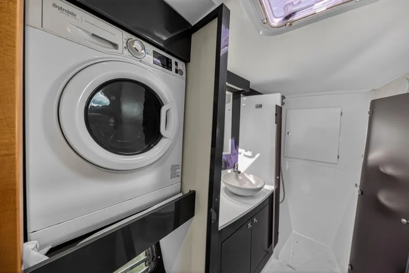 Slide: The Image of Laundry area and bathroom inside a 2014 Fountaine Pajot Helia 44 catamaran. - 66