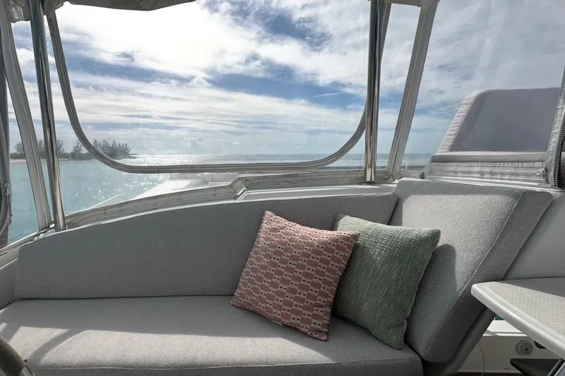 Slide: The Image of Interior view of 2014 Fountaine Pajot Helia 44 catamaran with cozy seating and ocean backdrop. - 7