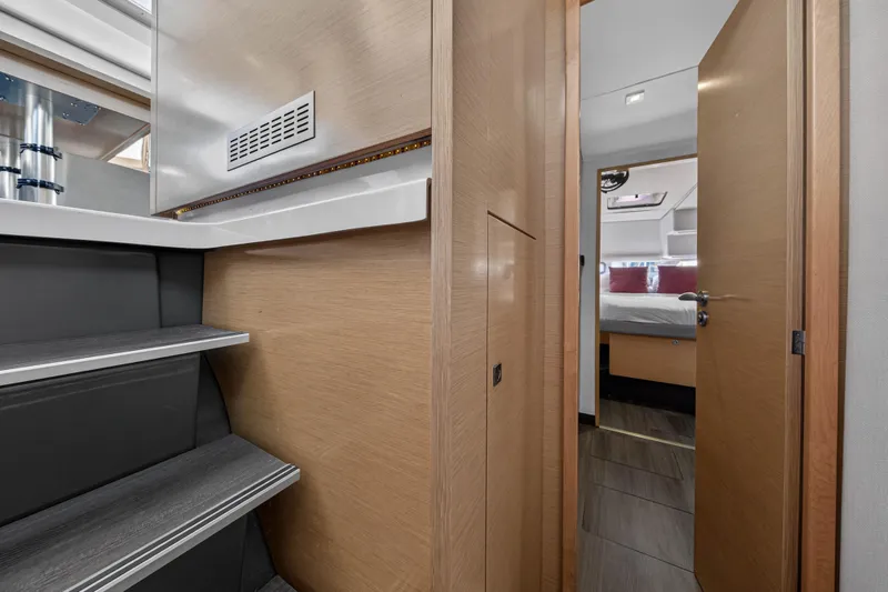 Slide: The Image of Interior of 2014 Fountaine Pajot Helia 44 catamaran, featuring modern wood finishes and cozy cabin. - 71