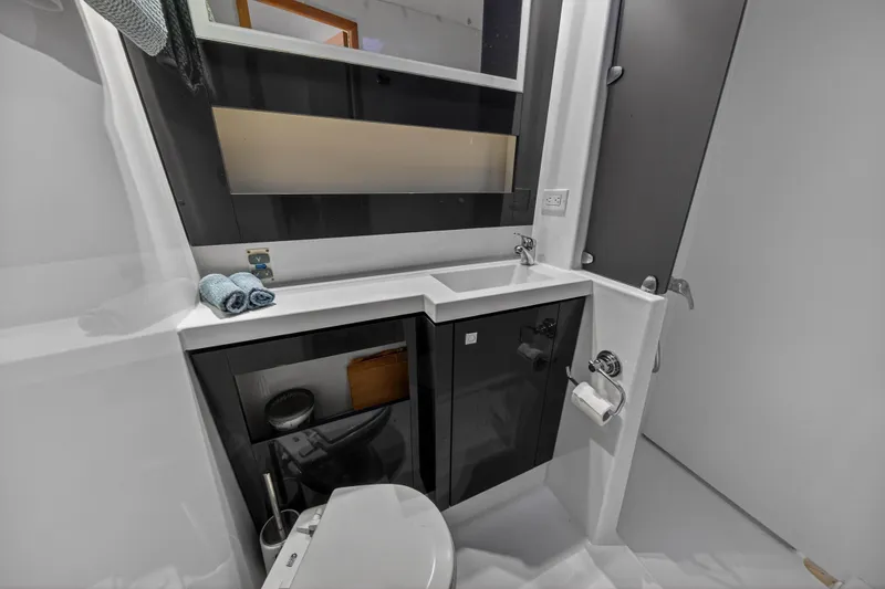 Slide: The Image of Modern bathroom in a 2014 Fountaine Pajot Helia 44 catamaran, featuring sleek design and amenities. - 73
