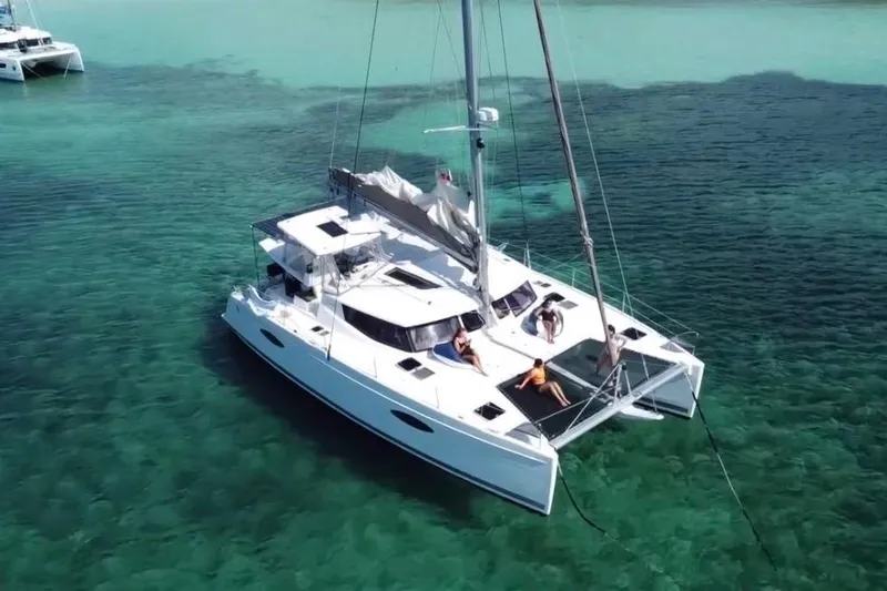 Slide: The Image of 2014 Fountaine Pajot Helia 44 catamaran sailing on clear turquoise waters. - 77