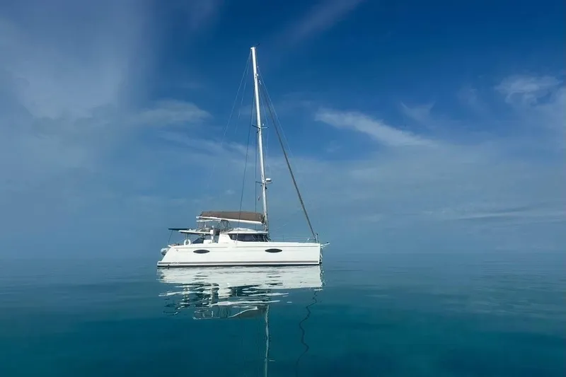 Slide: The Image of 2014 Fountaine Pajot Helia 44 catamaran sailing on calm, clear blue waters under a bright sky. - 78