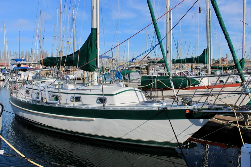 The Image of 1997 Valiant 39 sailboat docked in a marina, surrounded by other boats. - 0