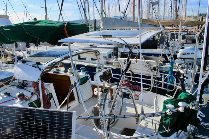 Slide: The Image of 1997 Valiant 39 sailboat docked, featuring solar panels and nautical equipment. - 10