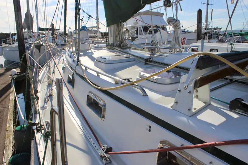 Slide: The Image of 1997 Valiant 39 sailboat docked at marina, showcasing deck and rigging details. - 11