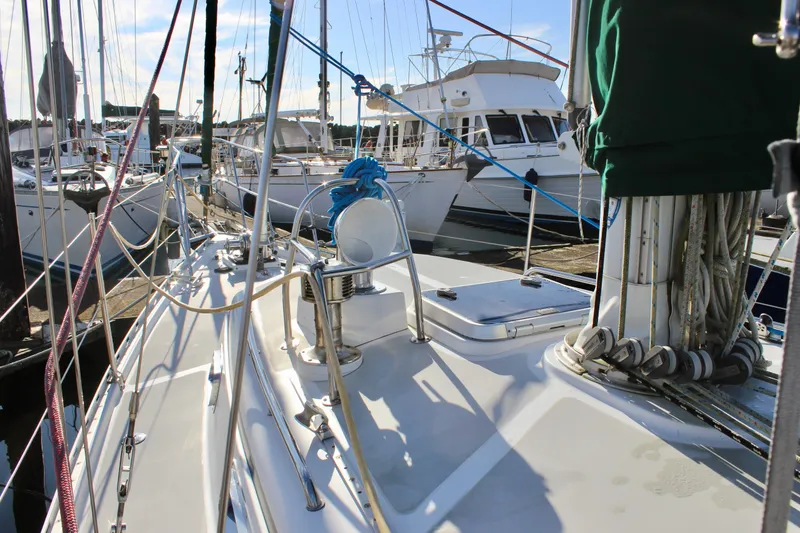 Slide: The Image of 1997 Valiant 39 sailboat docked in a marina, surrounded by other boats. - 12