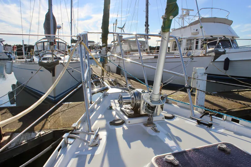 Slide: The Image of Sailboats docked at marina, featuring a 1997 Valiant 39 in the foreground. - 13