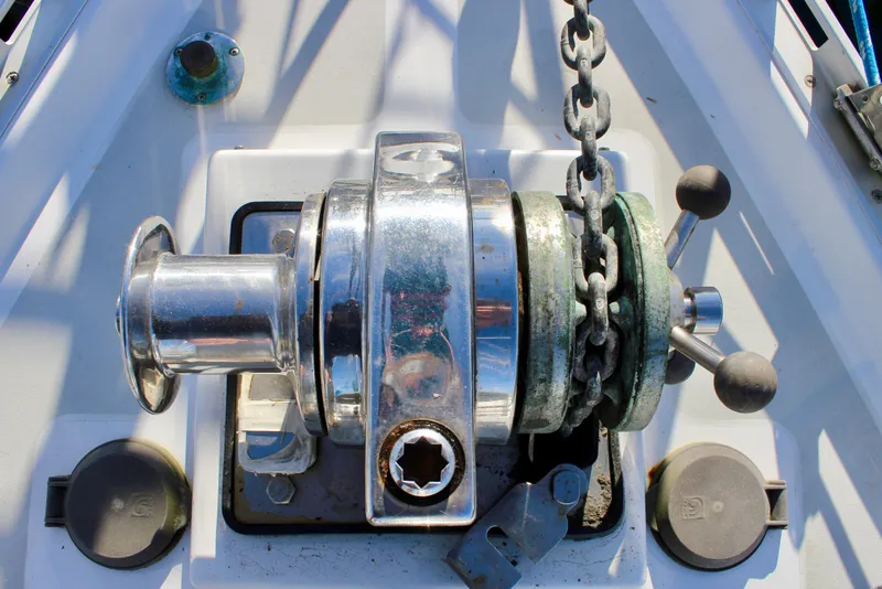 Slide: The Image of Anchor windlass on a 1997 Valiant 39 sailboat deck, featuring chain and controls. - 14