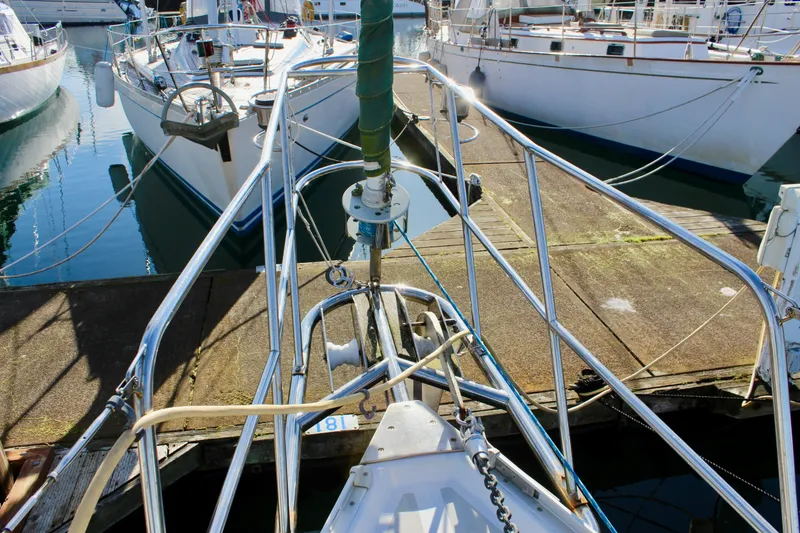 Slide: The Image of Sailboat docked at marina, Valiant 39, 1997 model, surrounded by calm water. - 16