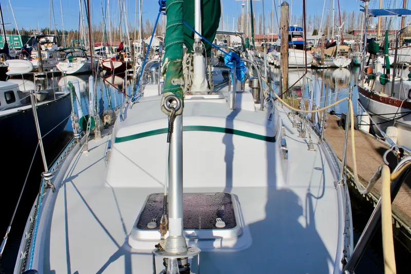 Slide: The Image of 1997 Valiant 39 sailboat docked in a marina, surrounded by other boats. - 17