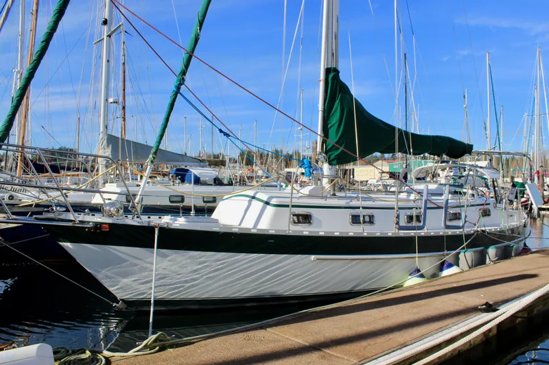 Slide: The Image of Sailboat docked at marina, 1997 Valiant 39 model, with green sail cover. - 2