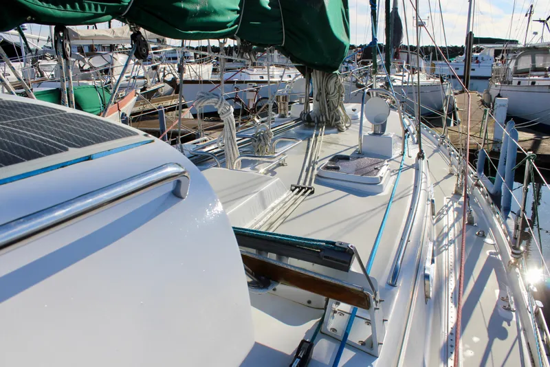 Slide: The Image of 1997 Valiant 39 sailboat deck with green sail cover, docked in marina. - 21