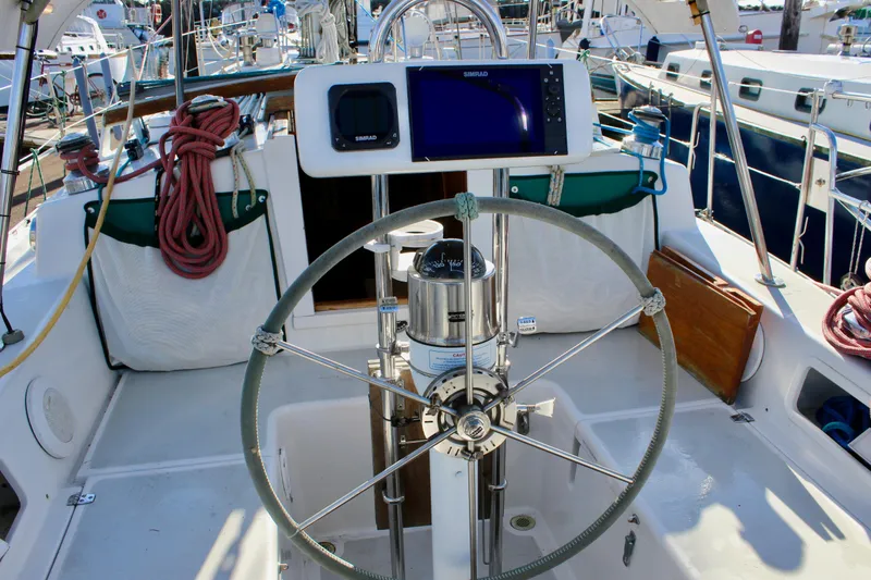 Slide: The Image of Cockpit of 1997 Valiant 39 sailboat with steering wheel and navigation equipment. - 23