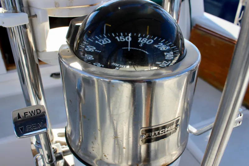 Slide: The Image of Compass and controls on a 1997 Valiant 39 sailboat. - 25