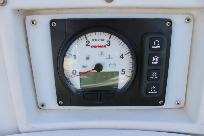 Slide: The Image of Yanmar engine control panel on 1997 Valiant 39 sailboat, featuring RPM gauge and control buttons. - 26