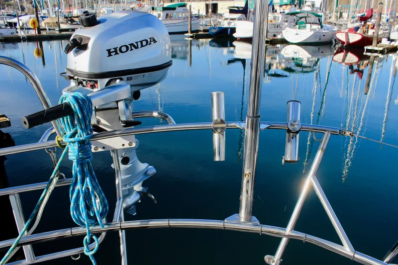 Slide: The Image of Outboard motor on a 1997 Valiant 39 sailboat, docked in a marina. - 30
