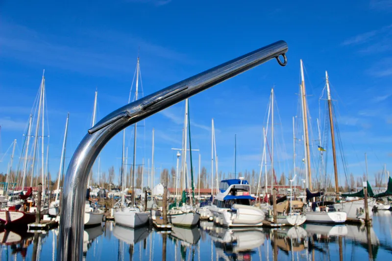 Slide: The Image of Chrome boat railing with marina background, featuring Valiant 39 sailboats, 1997 model. - 31