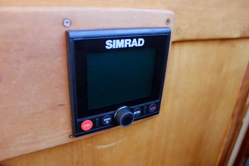 Slide: The Image of Simrad control panel on 1997 Valiant 39 boat, mounted on wooden surface. - 33