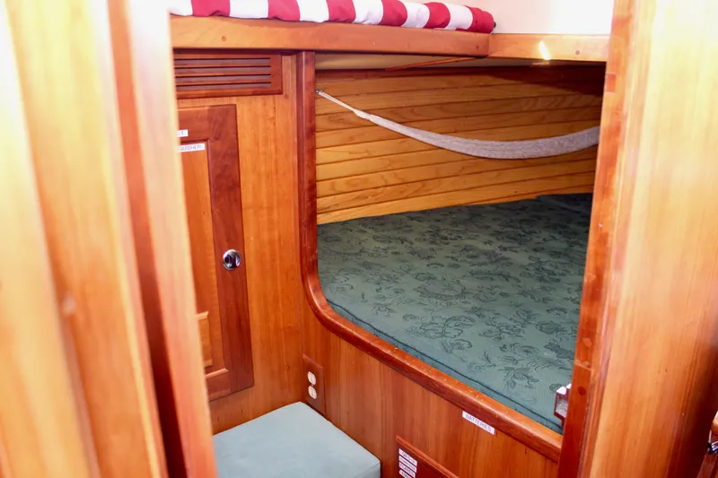 Slide: The Image of Cozy cabin interior of 1997 Valiant 39 sailboat with wooden finish and green bedding. - 35