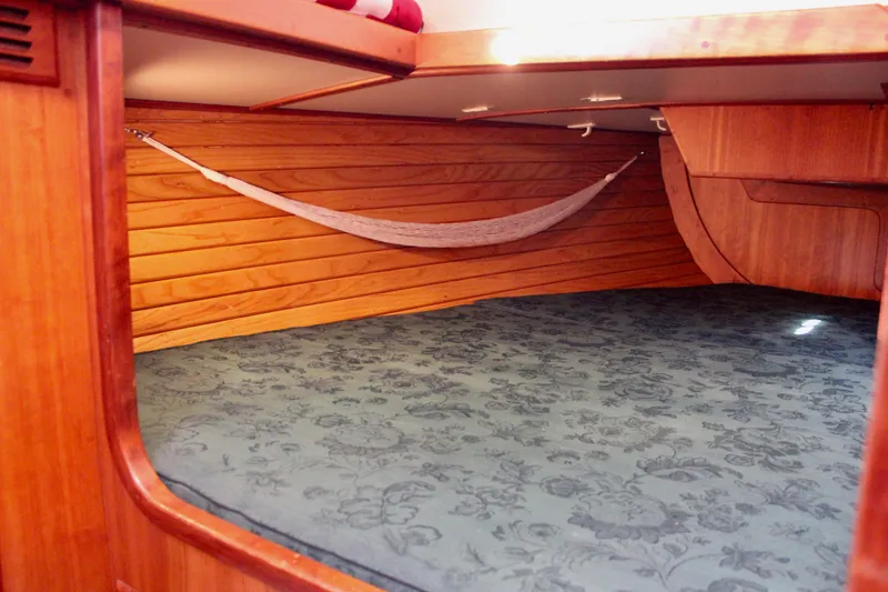 Slide: The Image of 1997 Valiant 39 yacht interior with wooden paneling and a cozy sleeping area. - 36