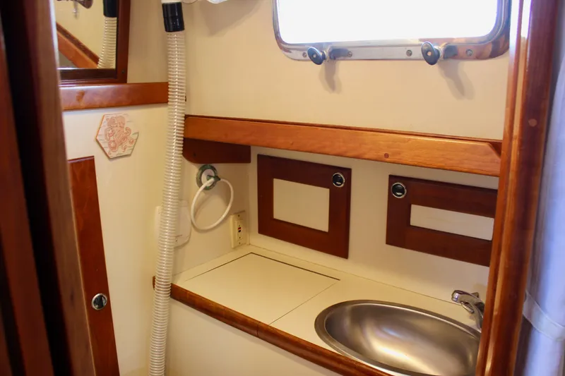 Slide: The Image of 1997 Valiant 39 yacht bathroom with wooden accents and stainless steel sink. - 38
