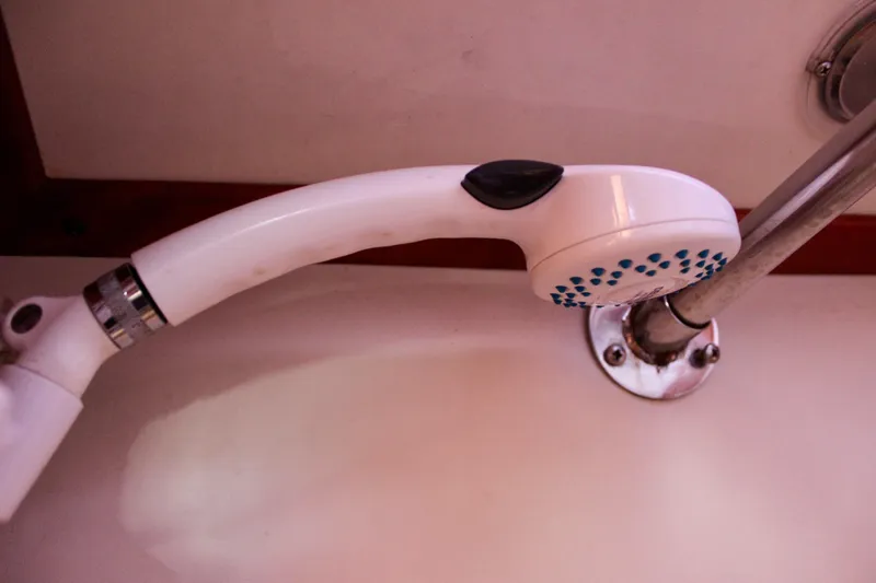 Slide: The Image of Showerhead in a 1997 Valiant 39 boat bathroom, mounted on a metal rod. - 42