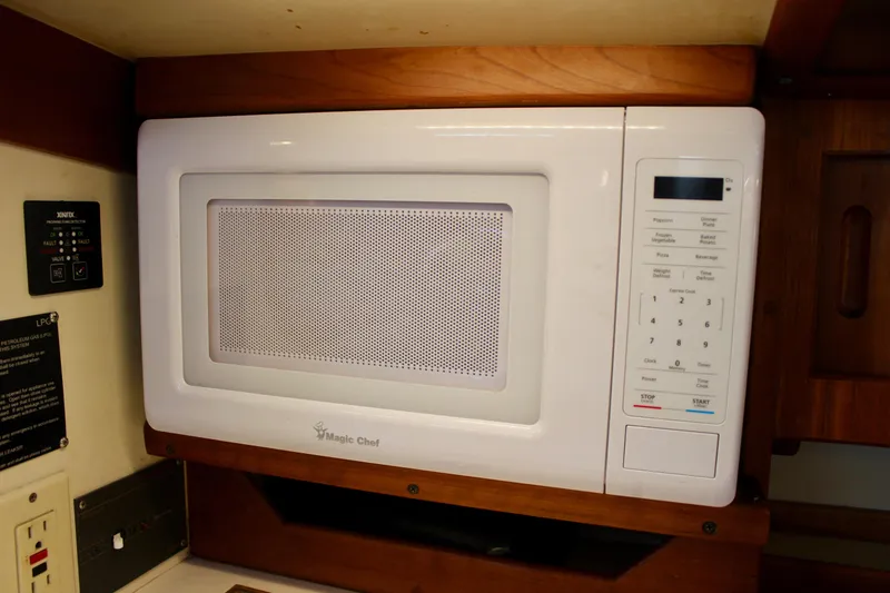 Slide: The Image of White Magic Chef microwave in a 1997 Valiant 39 yacht kitchen. - 48