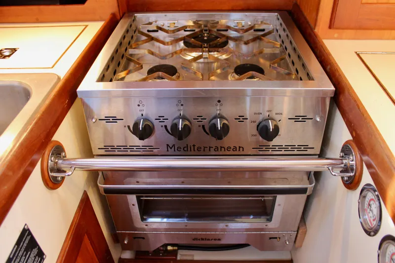 Slide: The Image of 1997 Valiant 39 yacht kitchen with Mediterranean stove and oven setup. - 49