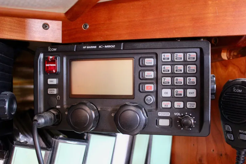 Slide: The Image of ICOM marine radio on 1997 Valiant 39 sailboat, featuring distress button and microphone. - 55