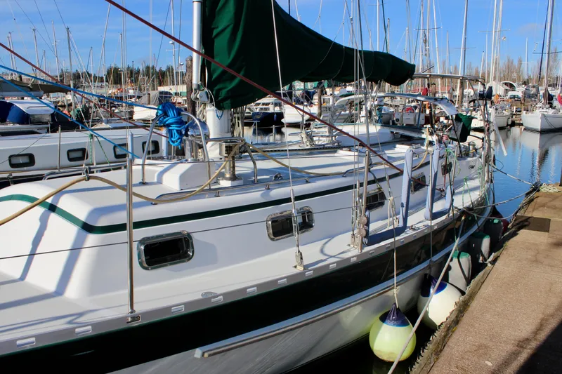 Slide: The Image of 1997 Valiant 39 sailboat docked in a marina, surrounded by other boats. - 6