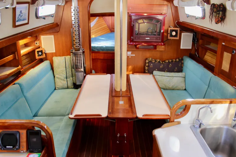 Slide: The Image of Interior of a 1997 Valiant 39 sailboat with cozy seating and wooden finishes. - 65