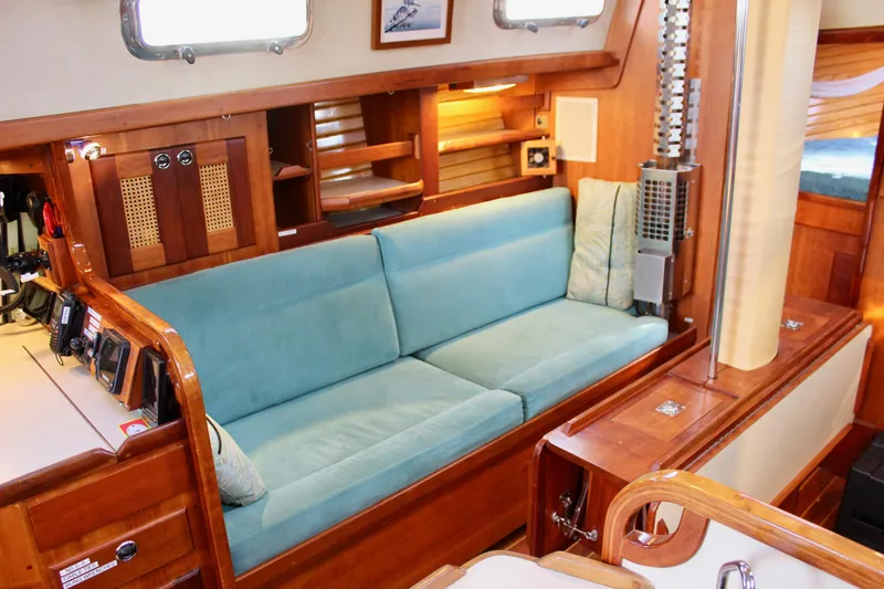 Slide: The Image of Interior of 1997 Valiant 39 yacht with teal sofa and wooden cabinetry. - 66
