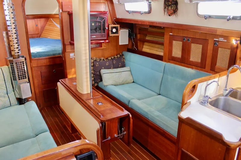 Slide: The Image of Cozy interior of 1997 Valiant 39 sailboat with wooden finishes and teal seating. - 67