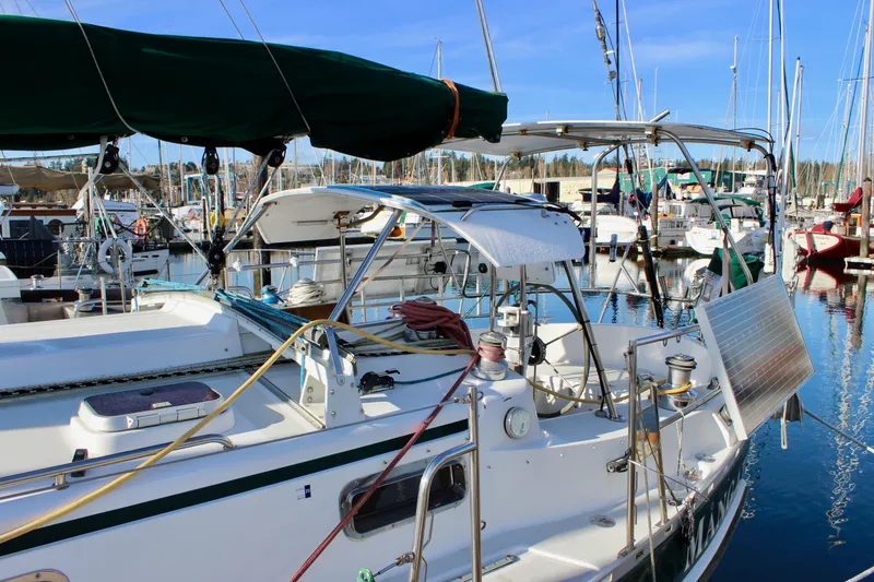 Slide: The Image of Sailboat Valiant 39, 1997 model, docked in a marina with solar panel and equipment. - 7