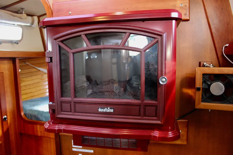 Slide: The Image of Red Duraflame heater inside a 1997 Valiant 39 boat cabin. - 70