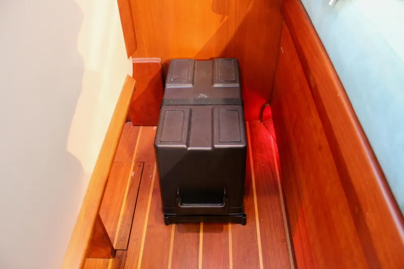Slide: The Image of Battery box on wooden floor of 1997 Valiant 39 boat interior. - 71