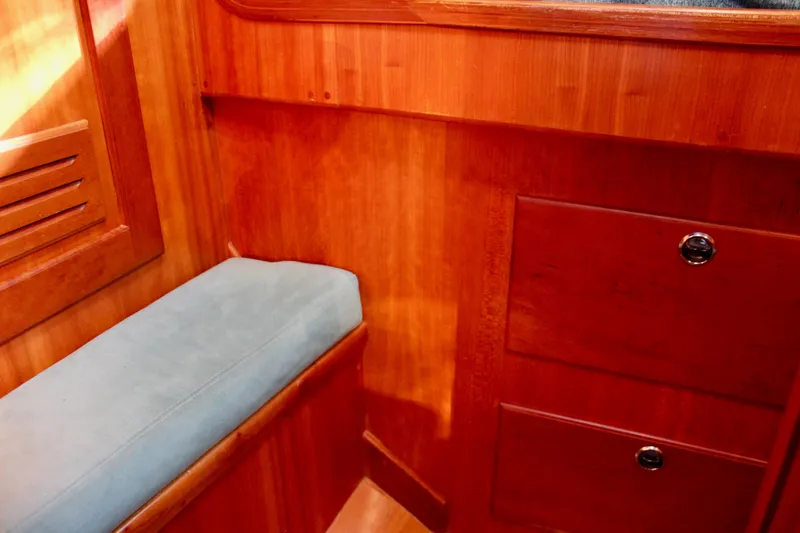 Slide: The Image of Interior of 1997 Valiant 39 sailboat with wooden cabinetry and cushioned seating. - 74
