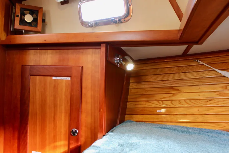 Slide: The Image of 1997 Valiant 39 yacht interior with wooden paneling and cozy cabin lighting. - 77