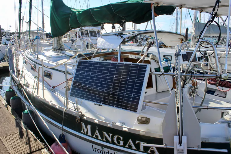 Slide: The Image of Valiant 39 sailboat from 1997 with solar panel, docked at marina. - 8