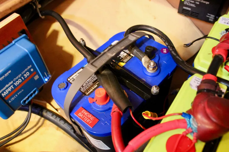 Slide: The Image of Battery setup in a 1997 Valiant 39, featuring MPPT charge controller and wiring connections. - 84