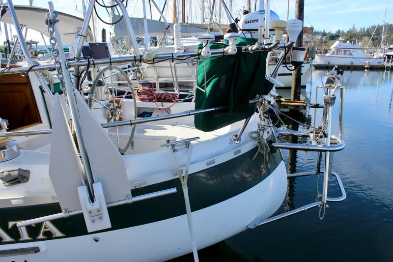 Slide: The Image of 1997 Valiant 39 sailboat docked, featuring a well-equipped cockpit and marina backdrop. - 9