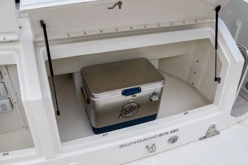 Slide: The Image of Manufacturer Provided Image: Sea Ray Sundancer 320 2020 model with storage compartment and cooler. - 13