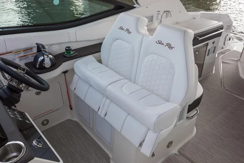 Slide: The Image of Manufacturer Provided Image: 2020 Sea Ray Sundancer 320 helm with white leather seats and modern controls. - 7