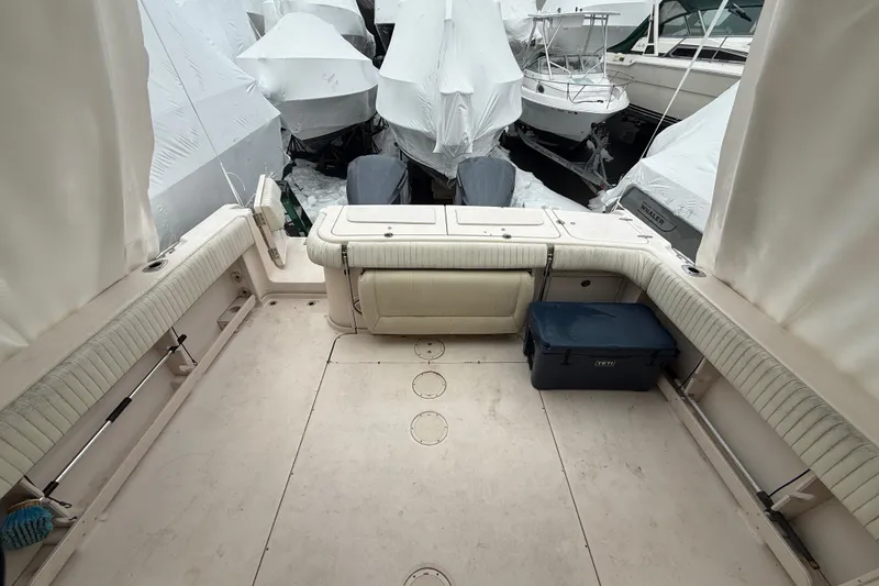 Slide: The Image of 2005 Grady-White Express 330 boat interior with covered seating and storage. - 14