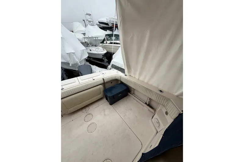 Slide: The Image of 2005 Grady-White Express 330 boat interior with covered seating and storage. - 15