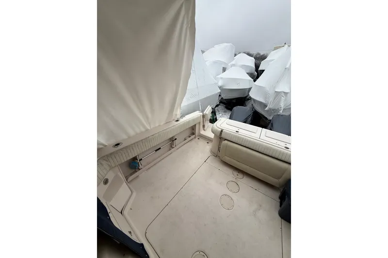 Slide: The Image of 2005 Grady-White Express 330 boat deck with covered seating and storage. - 16