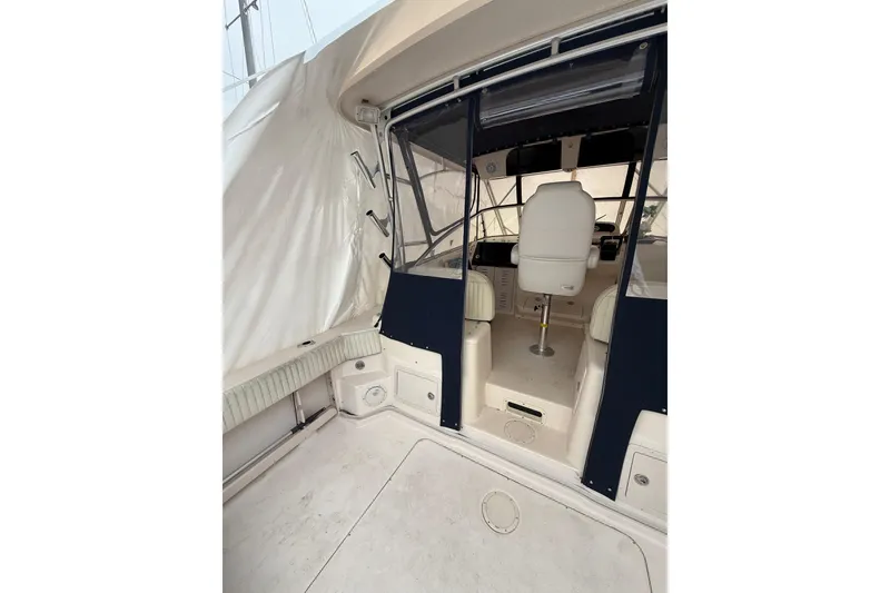Slide: The Image of 2005 Grady-White Express 330 boat interior with helm and seating area. - 17