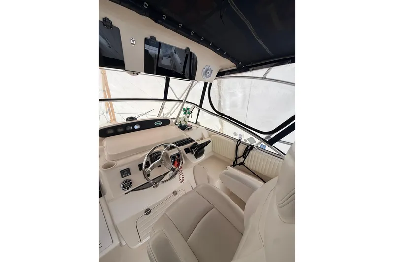 Slide: The Image of 2005 Grady-White Express 330 boat interior with steering wheel and seating. - 22