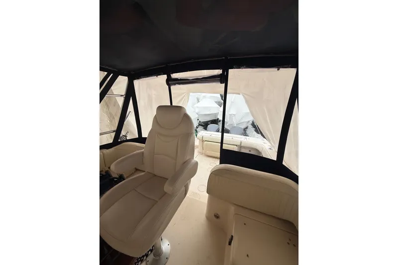 Slide: The Image of Interior view of 2005 Grady-White Express 330 boat with beige seating and covered windows. - 24